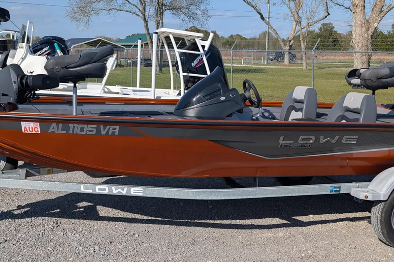 The Image of 2022 Lowe Stinger 175 boat on trailer, parked outdoors, featuring sleek design and comfortable seating. - 1