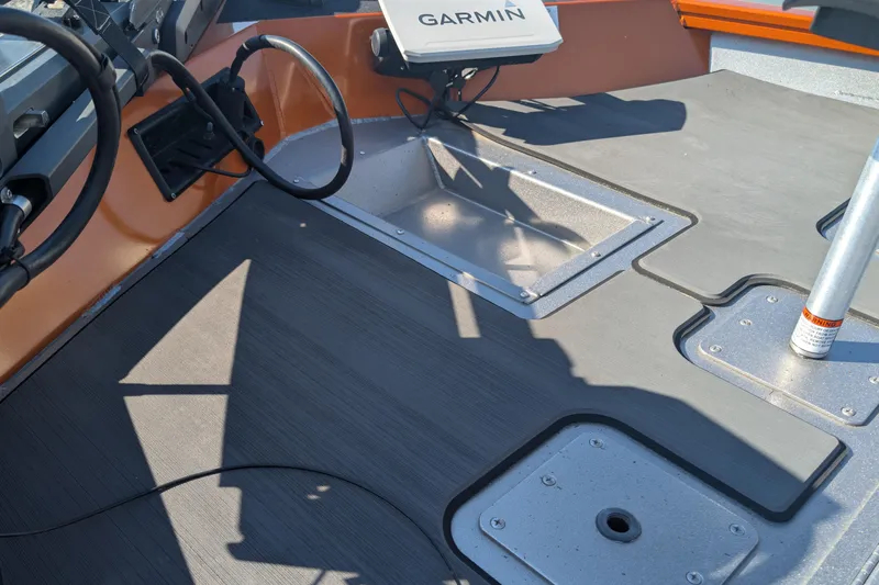 Slide: The Image of 2022 Lowe Stinger 175 boat deck with Garmin equipment and storage compartments. - 5