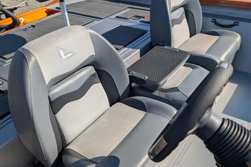 Slide: The Image of 2022 Lowe Stinger 175 boat interior with gray seating and steering wheel. - 7