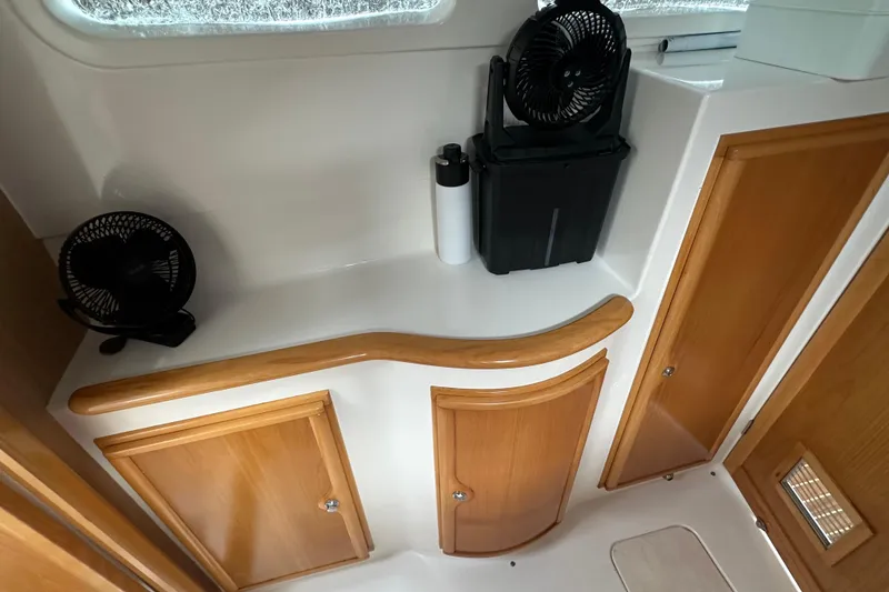 Slide: The Image of Interior of 2005 Seawind 1160 with wooden cabinets and fans. - 23