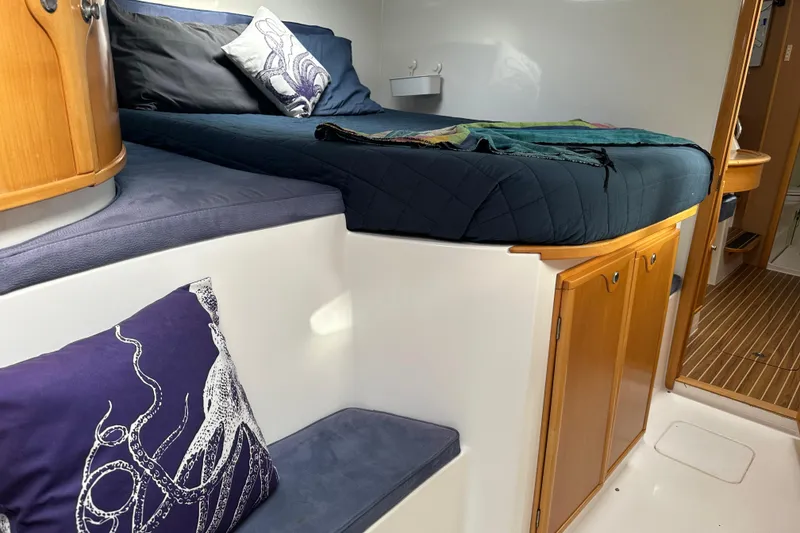 Slide: The Image of Cozy cabin interior of 2005 Seawind 1160 catamaran with comfortable bedding and nautical decor. - 25