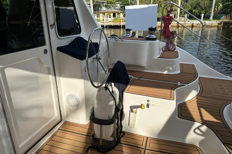 Slide: The Image of Cockpit of 2005 Seawind 1160 catamaran with wooden deck and steering wheel. - 9