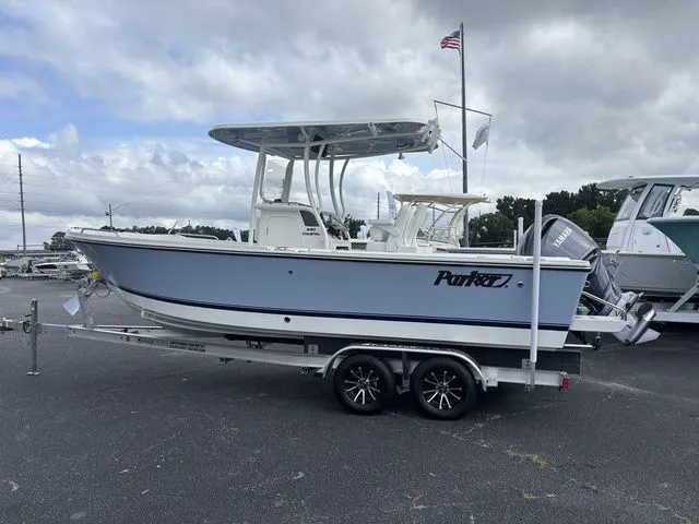 The Image of Parker 230 Coastal boat from 2026 on a trailer, featuring a T-top and outboard motor. - 1