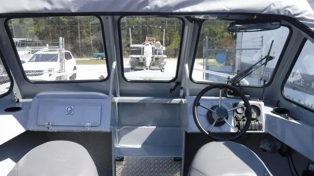 Slide: The Image of Interior view of a 2018 Hewescraft Sportsman 160 boat with steering console. - 9
