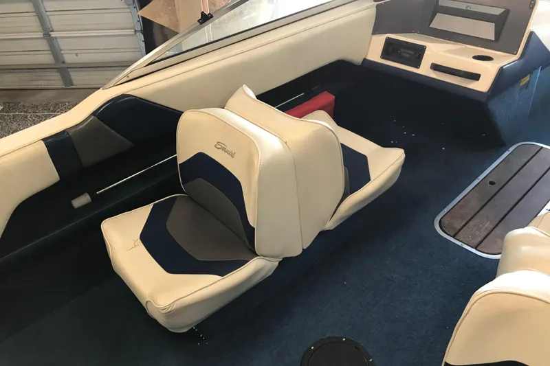 Slide: The Image of Interior of a 1992 Seaswirl 190 Bowrider I/O boat with beige and blue seating. - 11