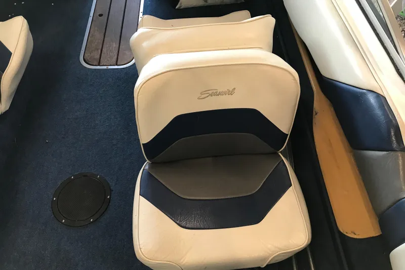 Slide: The Image of 1992 Seaswirl 190 Bowrider I/O boat interior with blue and white seating. - 12