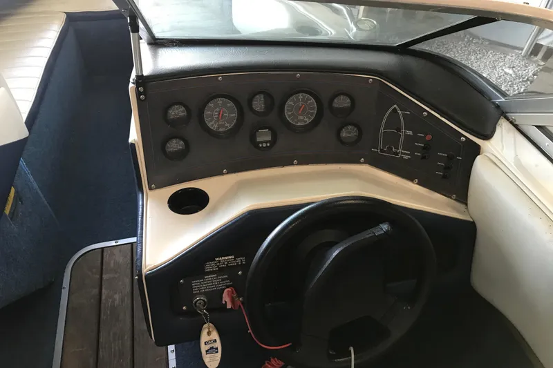 Slide: The Image of 1992 Seaswirl 190 Bowrider I/O dashboard with gauges and steering wheel in cockpit. - 15