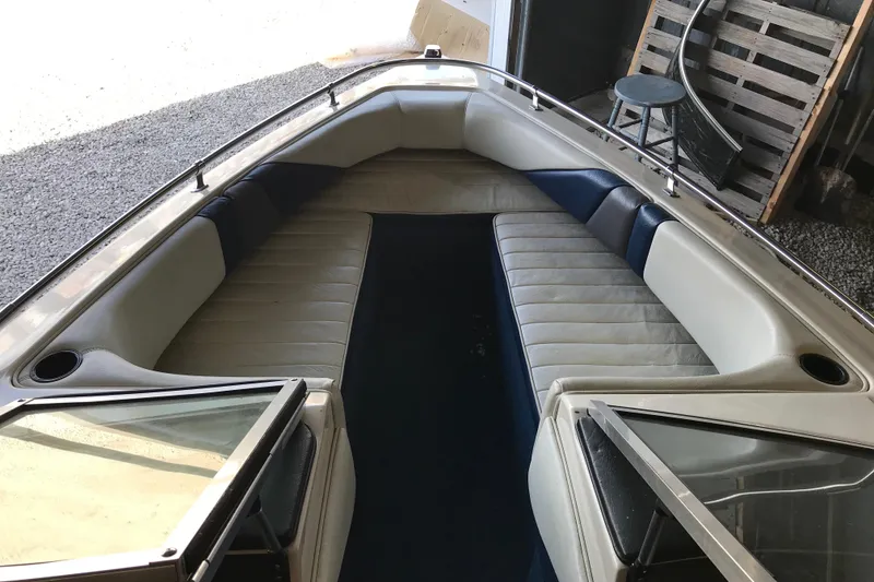 Slide: The Image of 1992 Seaswirl 190 Bowrider I/O interior with cushioned seating and open windshield. - 16