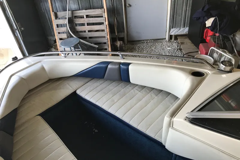 Slide: The Image of 1992 Seaswirl 190 Bowrider I/O interior with white and blue seating in storage. - 17