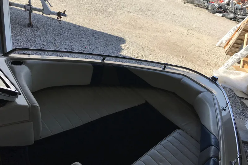 Slide: The Image of 1992 Seaswirl 190 Bowrider I/O interior with cushioned seating and open bow area. - 19