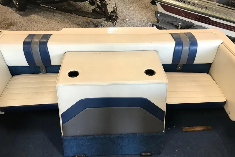 Slide: The Image of 1992 Seaswirl 190 Bowrider I/O boat interior with blue and white seating. - 23