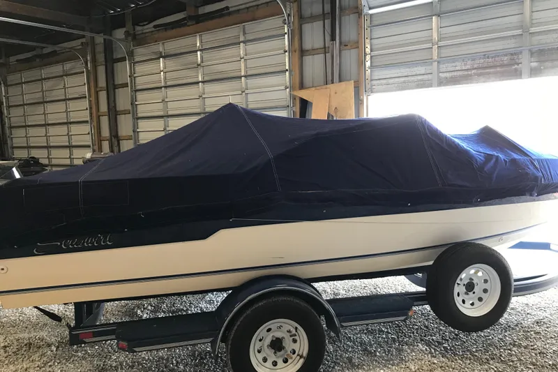 Slide: The Image of 1992 Seaswirl 190 Bowrider I/O boat covered in a garage on a trailer. - 26
