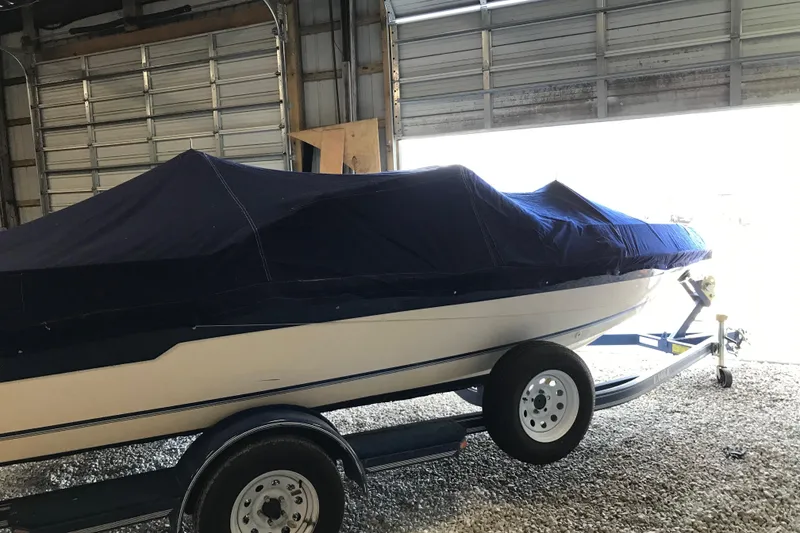 Slide: The Image of 1992 Seaswirl 190 Bowrider I/O boat covered in a garage, on a trailer. - 27