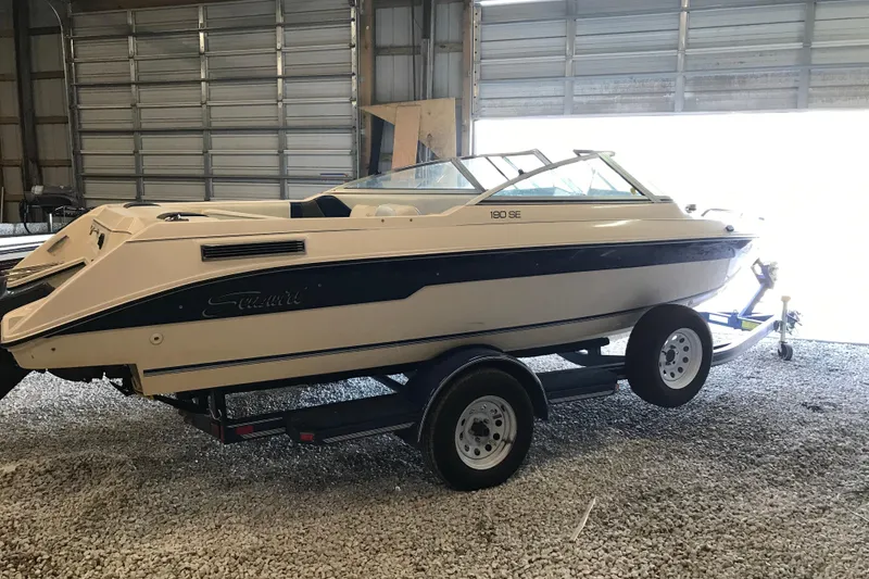 Slide: The Image of 1992 Seaswirl 190 Bowrider I/O boat on trailer in a garage setting. - 6
