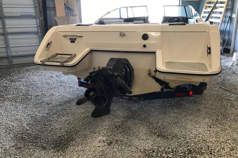 Slide: The Image of 1992 Seaswirl 190 Bowrider I/O boat in storage, showcasing rear view and propeller. - 7
