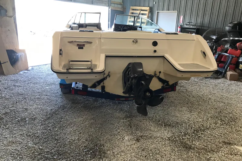 Slide: The Image of 1992 Seaswirl 190 Bowrider I/O boat in storage, rear view showing propeller and hull. - 8