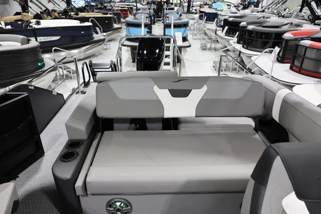 Slide: The Image of Evotti 521 CS 2026 boat with gray seating area at a show. - 17
