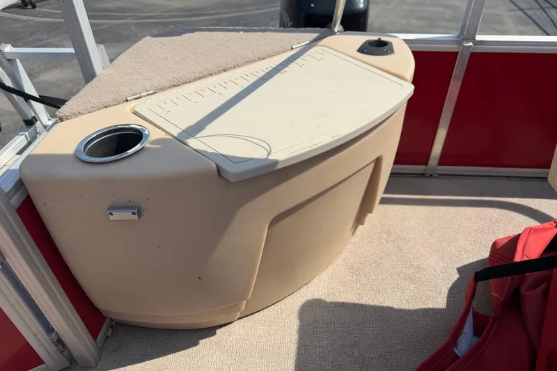 Slide: The Image of 2016 Sun Tracker Bass Buggy 18 DLX boat interior with cup holder and storage compartment. - 10