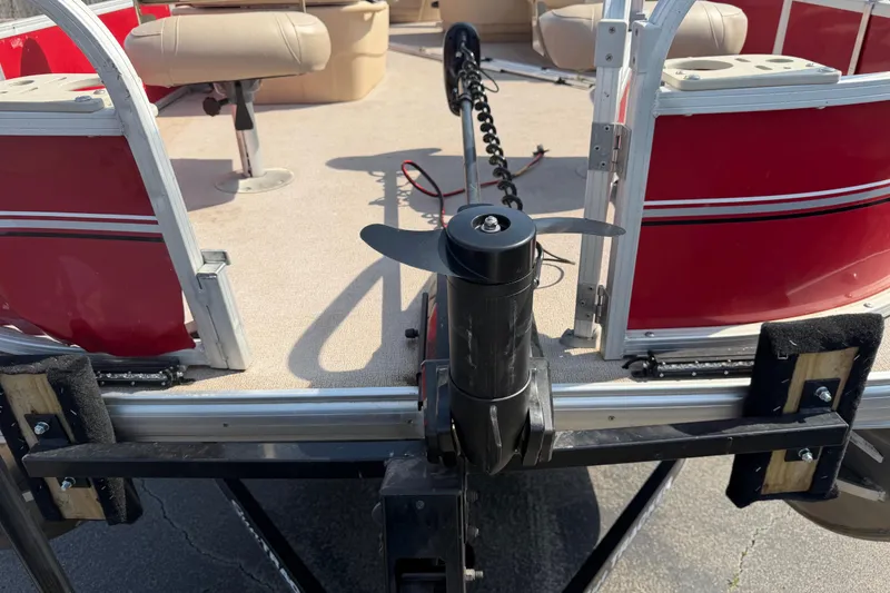 Slide: The Image of 2016 Sun Tracker Bass Buggy 18 DLX pontoon boat with red exterior and beige seating. - 4