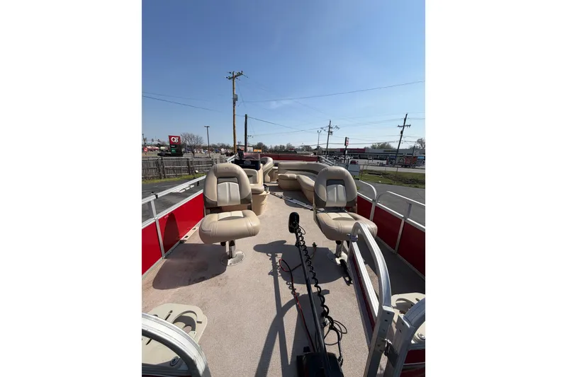 Slide: The Image of 2016 Sun Tracker Bass Buggy 18 DLX pontoon boat with beige seating and red exterior. - 5