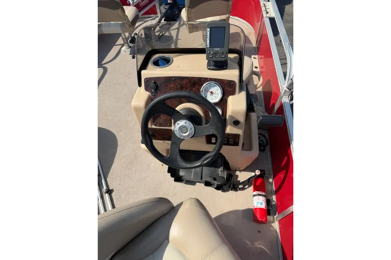 Slide: The Image of 2016 Sun Tracker Bass Buggy 18 DLX dashboard with steering wheel and navigation equipment. - 7