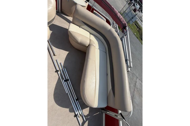 Slide: The Image of 2016 Sun Tracker Bass Buggy 18 DLX pontoon boat with beige seating and metal railings. - 9