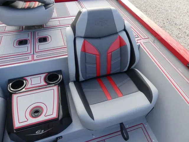 Slide: The Image of G3 Sportsman 1710 SE 2026 boat seat with red accents and cup holders. - 13