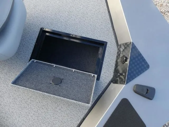 Slide: The Image of G3 Sportsman 1810 PFX 2026 boat with open storage compartment. - 19