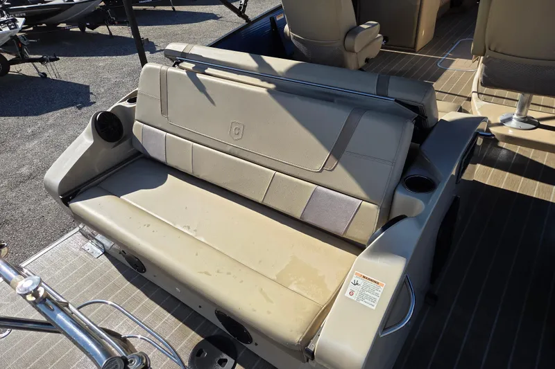 Slide: The Image of Beige seating on 2020 Godfrey AquaPatio 235 C pontoon boat with cup holders and speakers. - 11