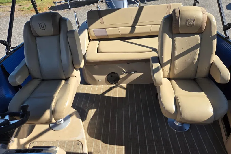 Slide: The Image of Interior of 2020 Godfrey AquaPatio 235 C with beige seating and steering wheel. - 14