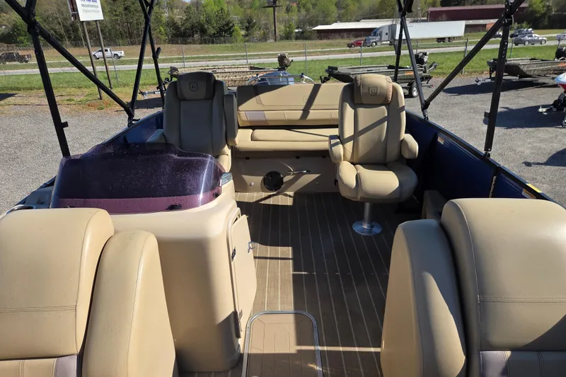 Slide: The Image of 2020 Godfrey AquaPatio 235 C pontoon boat interior with beige seating and wood flooring. - 15