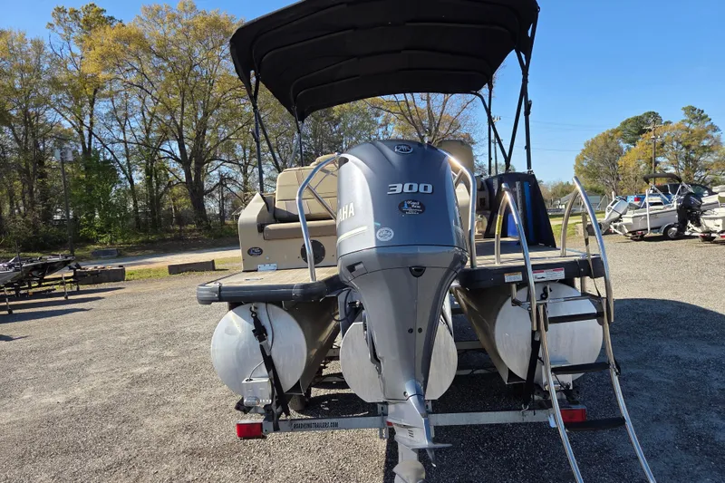 Slide: The Image of 2020 Godfrey AquaPatio 235 C pontoon boat with Yamaha 300 engine, parked outdoors. - 5