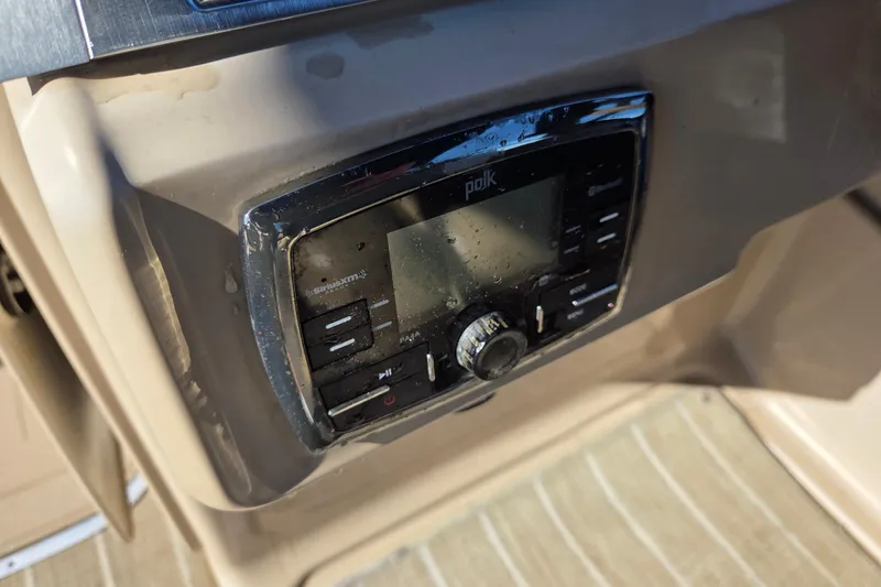 Slide: The Image of Polk audio system on 2020 Godfrey AquaPatio 235 C boat dashboard. - 16