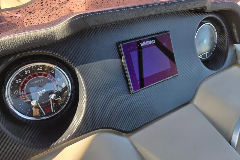 Slide: The Image of Dashboard of 2020 Godfrey AquaPatio 235 C with Simrad display and speedometer. - 17