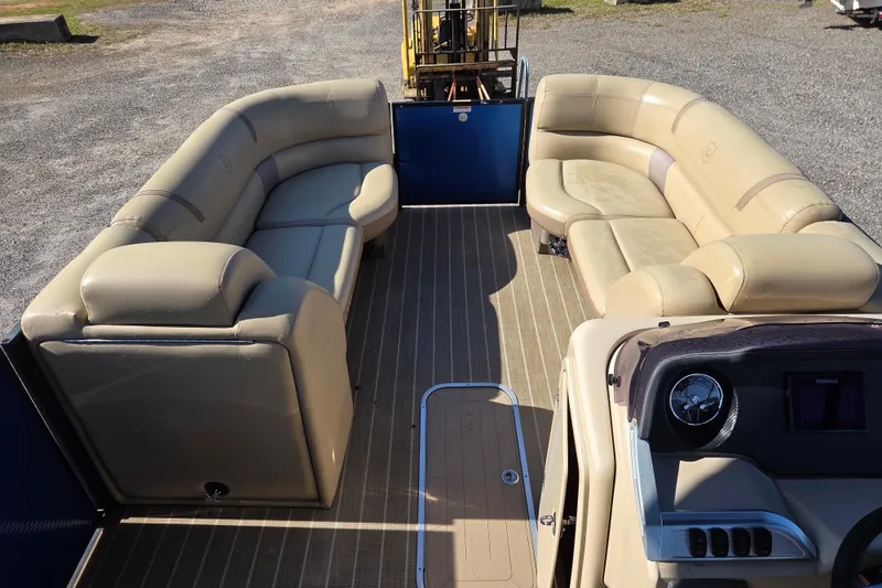 Slide: The Image of 2020 Godfrey AquaPatio 235 C pontoon boat interior with beige seating and wood-style flooring. - 7