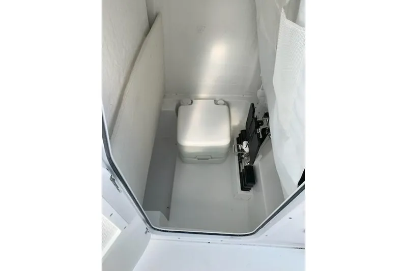 Slide: The Image of 2026 Sea Hunt Ultra 239 SE boat interior with compact marine toilet. - 11