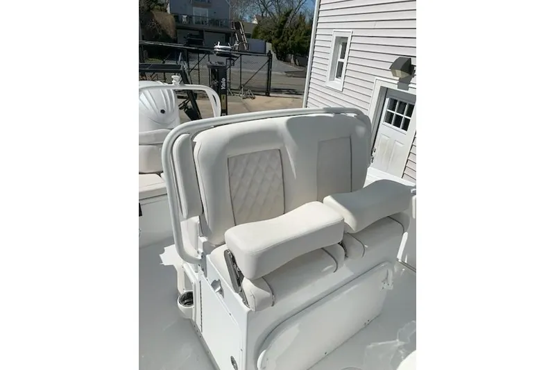 Slide: The Image of White seating on 2026 Sea Hunt Ultra 239 SE boat, featuring diamond-patterned upholstery. - 12