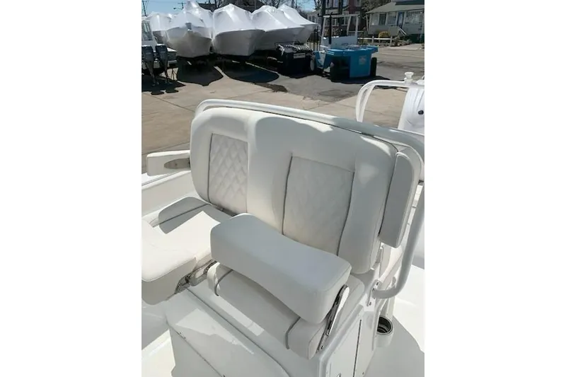 Slide: The Image of 2026 Sea Hunt Ultra 239 SE boat with white cushioned seating. - 13