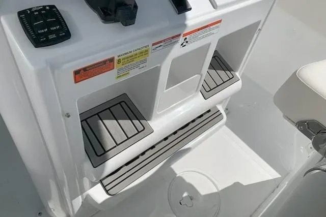 Slide: The Image of 2026 Sea Hunt Ultra 239 SE boat console with footrests and control panel. - 17
