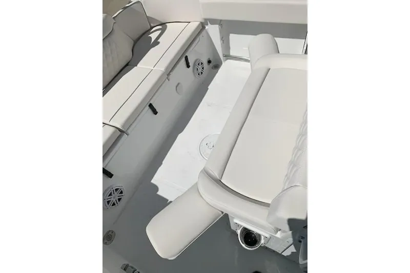 Slide: The Image of Interior view of 2026 Sea Hunt Ultra 239 SE boat with white seating and speakers. - 19