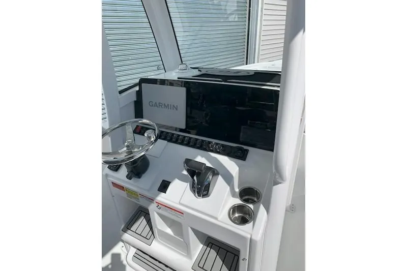 Slide: The Image of 2026 Sea Hunt Ultra 239 SE boat console with Garmin navigation system. - 7