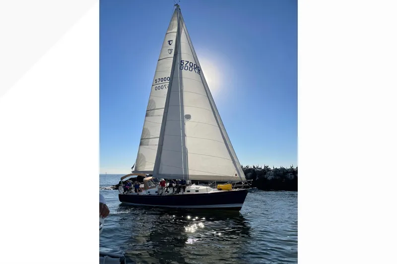 The Image of Sailboat Tartan 4000 (2016) gliding on water under clear blue sky. - 0