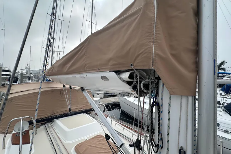 Slide: The Image of Sailboat Tartan 4000, 2016 model, docked with tan sail cover and rigging visible. - 12