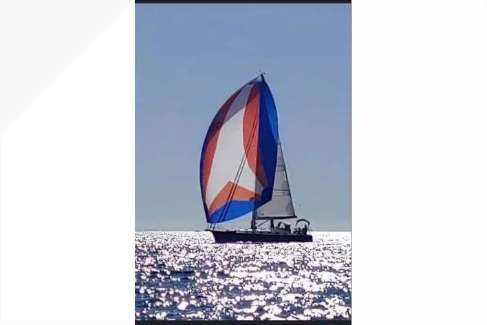 Slide: The Image of Sailboat Tartan 4000 (2016) with colorful spinnaker on sparkling sea. - 2