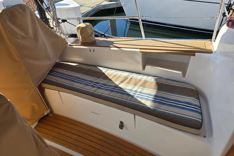 Slide: The Image of Cozy seating area on a 2016 Tartan 4000 yacht with striped cushions and wooden accents. - 24