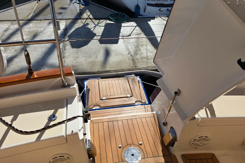 Slide: The Image of Tartan 4000 yacht deck, 2016 model, featuring teak flooring and open hatch. - 25