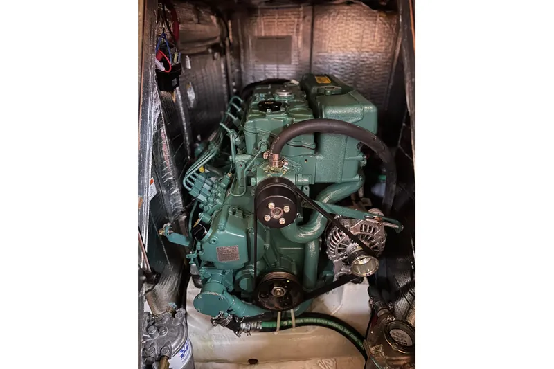 Slide: The Image of Engine compartment of a 2016 Tartan 4000 sailboat, showcasing a green marine engine. - 28