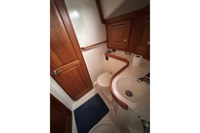 Slide: The Image of Compact bathroom in 2016 Tartan 4000 yacht with wooden cabinetry and modern fixtures. - 30