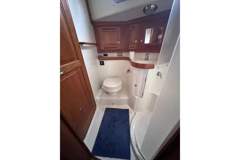 Slide: The Image of Bathroom interior of 2016 Tartan 4000 yacht with wooden cabinetry and blue rug. - 31