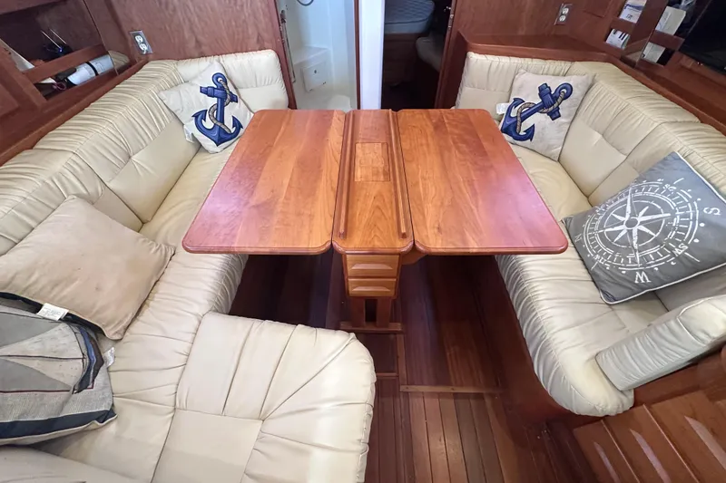 Slide: The Image of Cozy Tartan 4000 yacht interior with wooden table and nautical-themed cushions, 2016 model. - 32